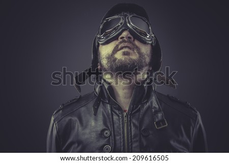retro pilot dressed in vintage style leather cap and goggles