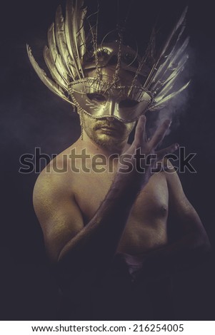golden bodypaint, man with gold helmet, ancient warrior deity