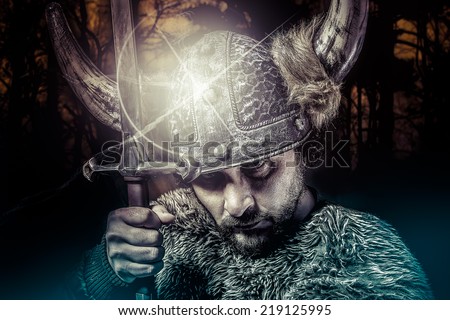 War, Viking warrior, male dressed in Barbarian style with sword, bearded