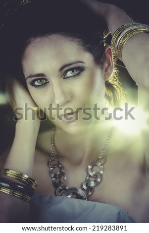 Beautiful woman with evening make-up. Jewelry and Beauty. Yellow light