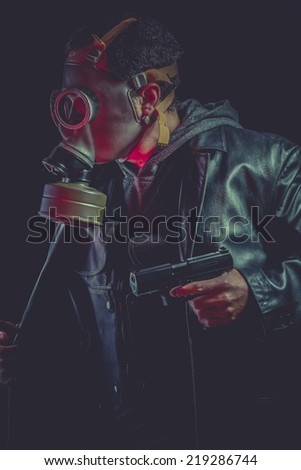 Armed man with gas mask and gun