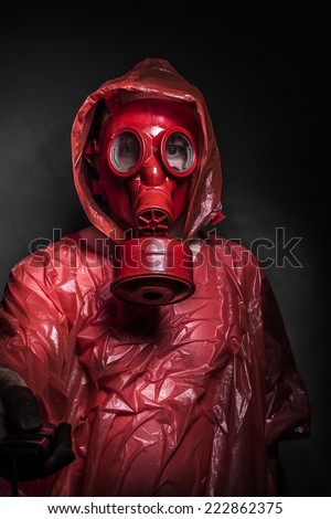 Horror, A man in a gas mask over  the smoke. black background and red colors