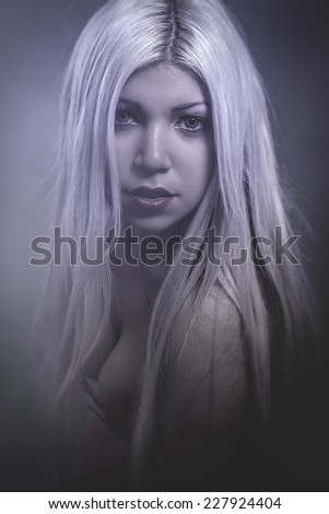 Sensual young woman with long hair, cold light