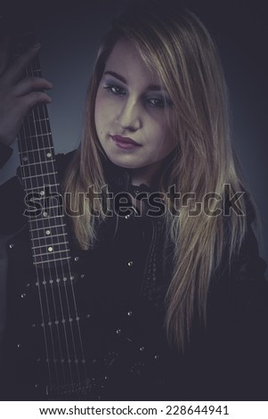 Music Star Pretty and beautiful blonde with black electric guitar