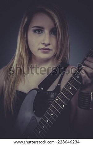 Heavy music, Beautiful blonde with black electric guitar