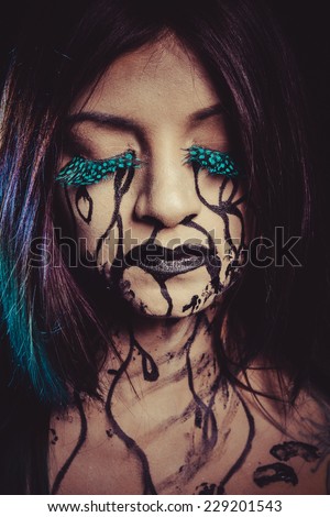 concept, crying woman with tears and makeup dark light