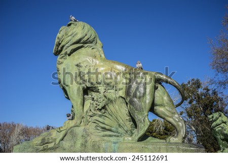 Lion, classical bronze sculptures, Lake in Retiro park, Madrid Spain