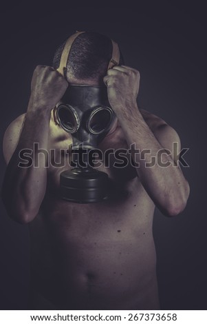 Danger ebola, concept of risk of contamination, naked man with gas mask