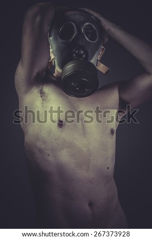 Danger, concept of risk of contamination, naked man with gas mask