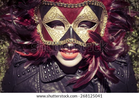 Sensual, beautiful woman with full lips and Venetian mask at sunset