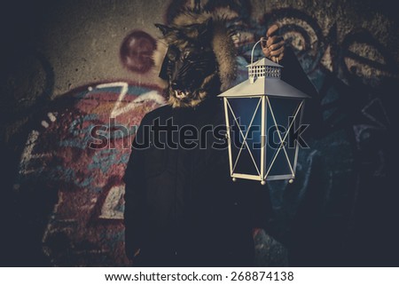 Scary, man with mask wolf and lamp with colored smoke