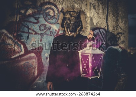 man with mask wolf and lamp with colored smoke