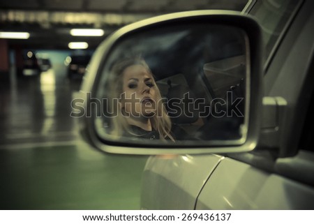 Vintage, blonde in car driving at night, dressed in jeans and leather jacket