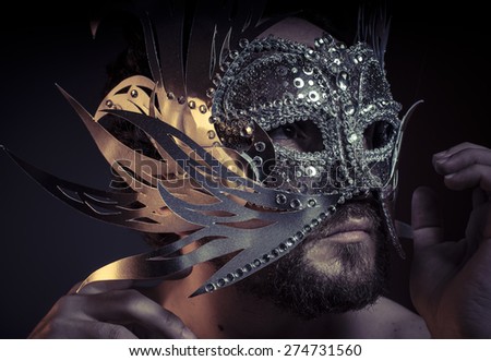 Fear, bearded man with silver mask Venetian style. Mystery and renaissance