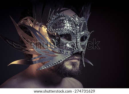 Theater, bearded man with silver mask Venetian style. Mystery and renaissance