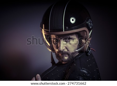 biker with motorcycle helmet and black leather jacket, metal studs
