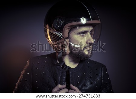 biker with motorcycle helmet and black leather jacket, metal studs