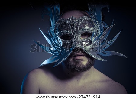 Costume, bearded man with silver mask Venetian style. Mystery and renaissance
