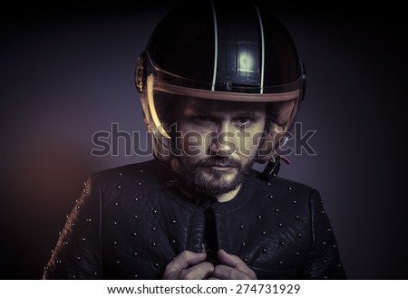 Motorbike, biker with motorcycle helmet and black leather jacket, metal studs