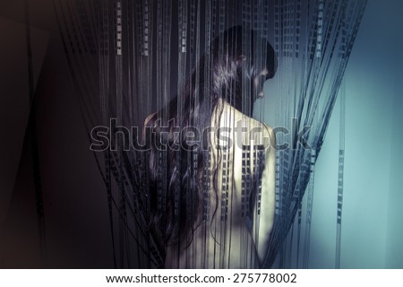 Skin, naked girl behind curtains of black threads
