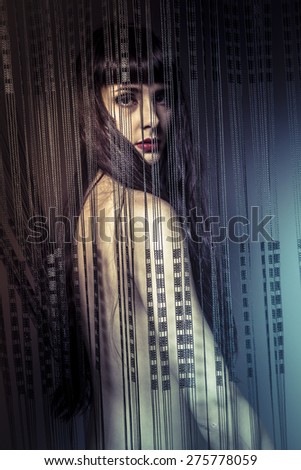 Fresh, naked girl behind curtains of black threads