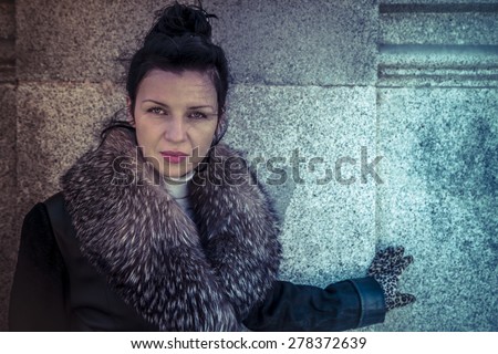 Russian woman in fur coat in a park in autumn