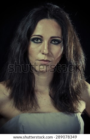 Trouble, sad brunette woman with long hair and evening gown