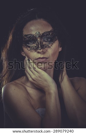 Skin, brunette woman in black mask metal frills