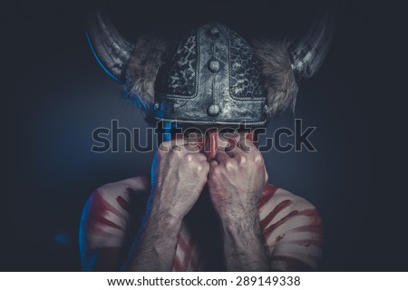 Leadership, Viking warrior with a horned helmet and war paint on his face