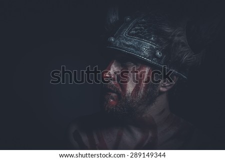 Aggression, Viking warrior with a horned helmet and war paint on his face