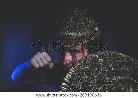 bearded man warrior with metal helmet and shield, wild Viking