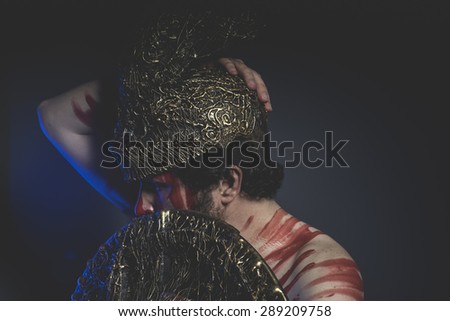 Medieval, bearded man warrior with metal helmet and shield, wild Viking