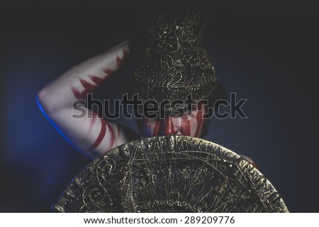 Soldier, bearded man warrior with metal helmet and shield, wild Viking