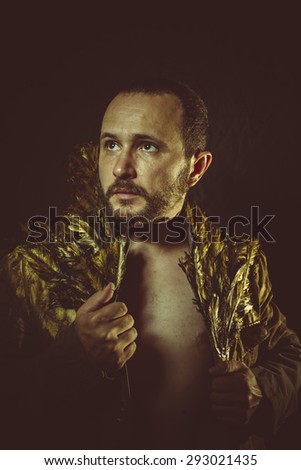 Modern warrior, jacket attractive man with golden feathers