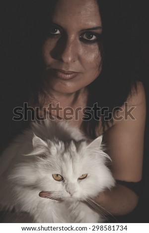 brunette woman with white Persian cat with long hair