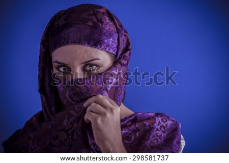 Muslim, Beautiful arabic woman with traditional veil on her face, intense look