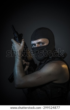Thief, Man wearing balaclavas and bulletproof vest with firearms