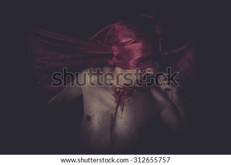 Reaper, naked man on large red cloth over his eyes