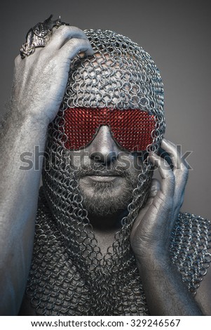 Soldier, man in chain mail and leather painted silver, medieval warrior