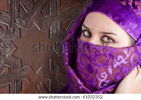 woman dressed in sahararaui costume, old wood gate background