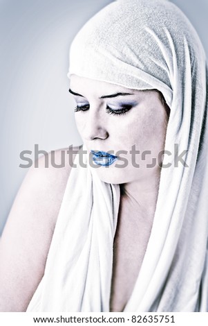 Winter concept. Portrait of a beautiful girl wearing white cloth.