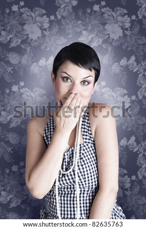 Portrait of surprised attractive brunette covering her mouth by the hands, over vintage background