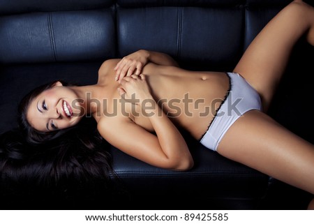 sexy beautiful young girl relax on black sofa