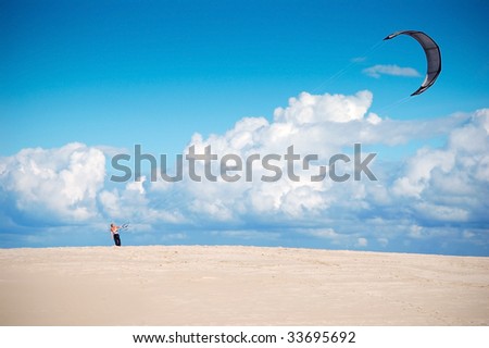 A man with a kite at Slowinski National Park sand dunes. Poland.