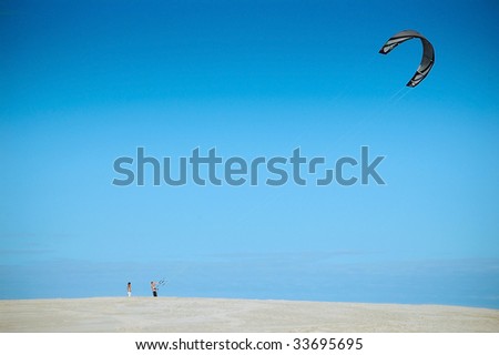A man with a kite at Slowinski National Park sand dunes. Poland.