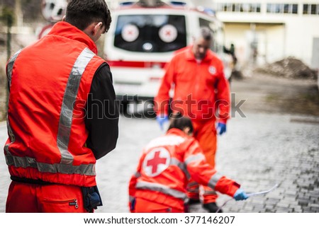 emergency operators with ambulance during accident