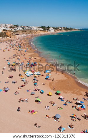 ALBUFEIRA, PORTUGAL - AUGUST 30: tourists and locals enjoying a sunny day at beach in Algarve on August 30, 2011 in Albufeira, Portugal.It is the most touristic place in the region during all year
