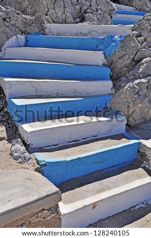traditional white and blue stairs in a Greek island