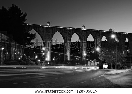 black and white night shoot of the historic aqueduct in the city of Lisbon built in 18th century, Portugal