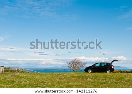 NORTHERN IRELAND - MAY 9: unidentified black suv at the countryside where a family decided to enjoy a holiday outdoors in Northern Ireland, United Kingdom on May 9, 2012.